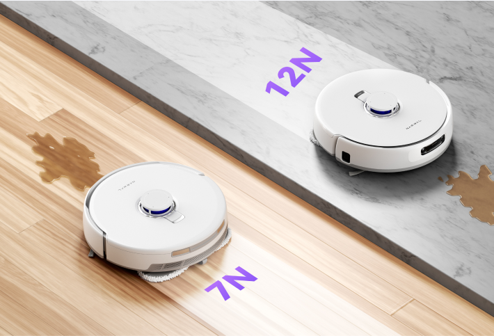 Narwal Freo Z Ultra robot vacuum demonstrating different pressure levels for cleaning, 7N on one surface and 12N on another, with liquid spill on the wooden floor.